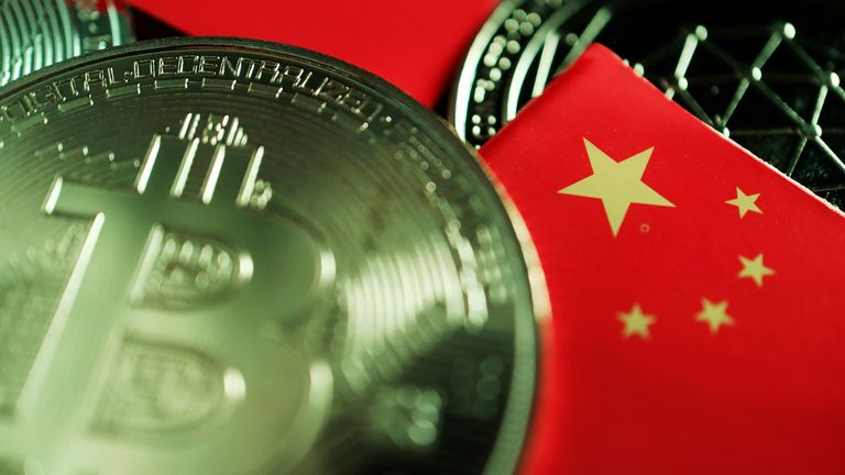 FILE PHOTO: A Chinese flag is seen among representations of Bitcoin and other cryptocurrencies in this illustration picture taken June 2, 2021. REUTERS/Florence Lo/Illustration/File Photo

