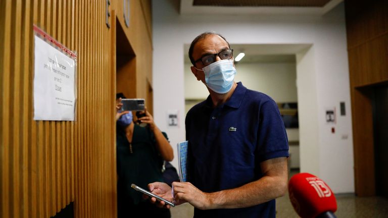 Shmuel Peleg, the grandfather of Eitan Biran, looks at his mobile phone before the start of a court hearing over the alleged kidnapping of Biran, a six-year-old boy who was the only survivor of an Italian cable car disaster and is now at the centre of a custody battle, at a court in Tel Aviv, Israel 