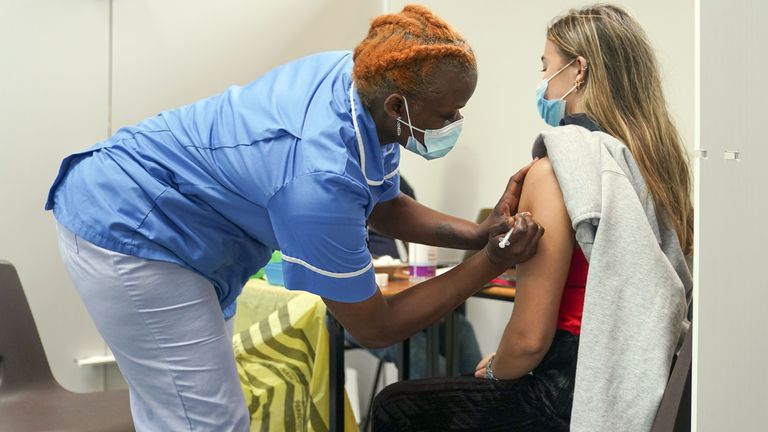 Nurse Marvis Birungi (left) gives a vaccine injection to Oxford Brookes University student Eleanor Seddon