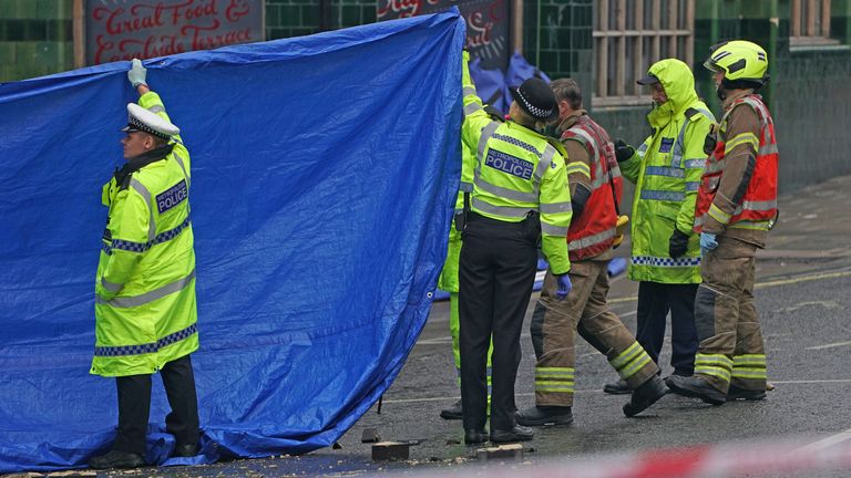 Emergency services at the scene on the Great Western Road, Notting Hill, west London, where three people have died after a vehicle collided with a residential block