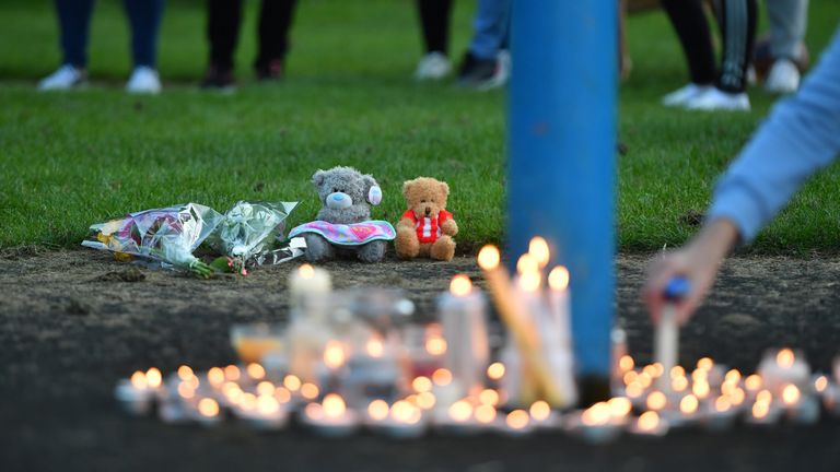 Flowers, soft toys and candles are seen at a vigil near to the scene in Chandos Crescent, Killamarsh