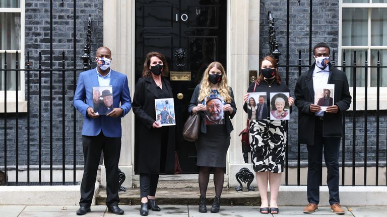 Members of the Covid-19 Bereaved Families for Justice group holding photos of loved ones outside 10 Downing Street after their private meeting with Prime Minister Boris Johnson, 398 days after he first promised to do so