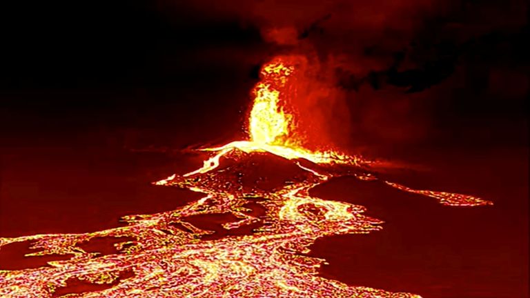 vScreen grab from a video taken by a night drone shows a volcano erupting and tongues of lava in La Palma, Spain September 22, 2021. Spanish Emergency Military Unit (UME)/ 