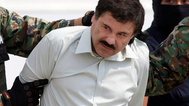 FILE - This Feb. 22, 2014 file photo shows Joaquin "El Chapo" Guzman, the head of Mexico&#39;s Sinaloa Cartel, being escorted to a helicopter in Mexico City following his capture in the beach resort town of Mazatlan. Attorneys for Guzman are asking for a new trial in light of what they say was jury misconduct during his drug conspiracy trial. (AP Photo/Eduardo Verdugo, File)                                                                                                                                                                                                         