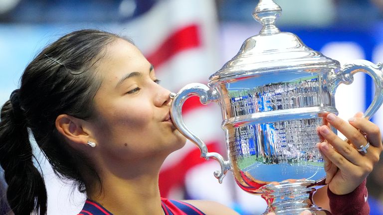 Emma Raducanu of Great Britain celebrates with the championship trophy after her match against Leylah Fernandez of Canada