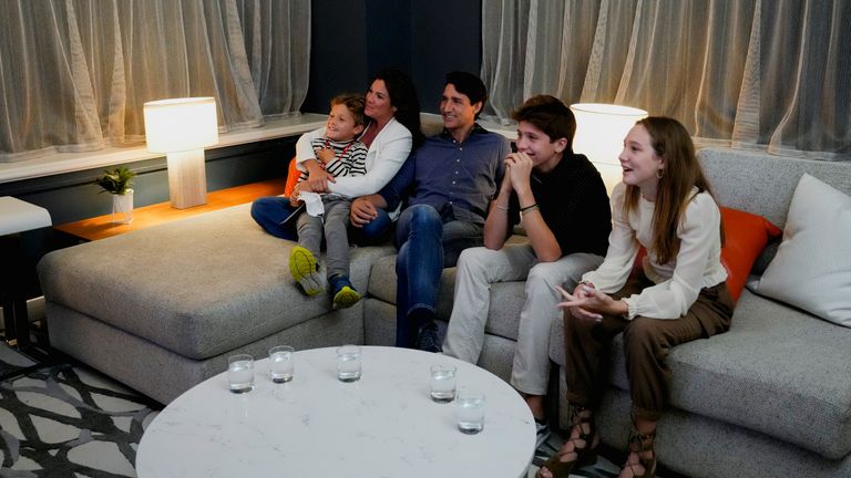 Canada&#39;s Liberal Prime Minister Justin Trudeau, accompanied by his wife Sophie Gregoire and his children Ella-Grace, Xavier and Hadrien watch the election coverage on a TV, in Montreal
