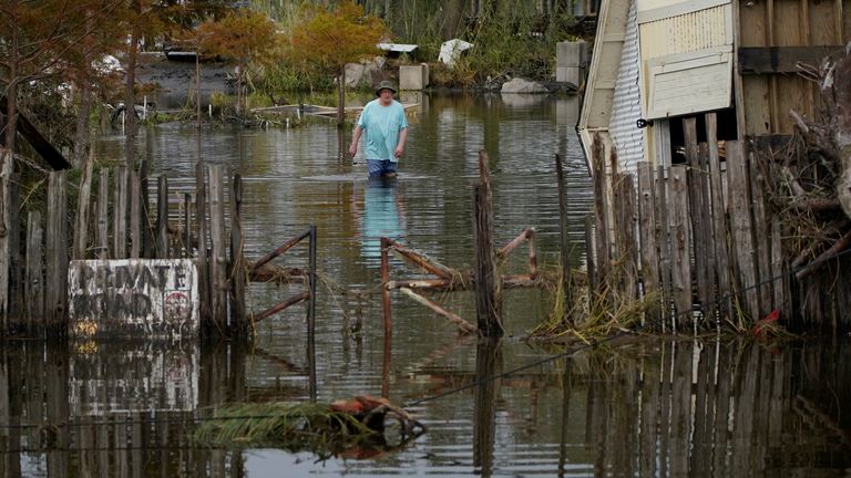 A man walks down a flooded street in the aftermath of Hurricane Ida - Picture date 1 August
PIC:AP