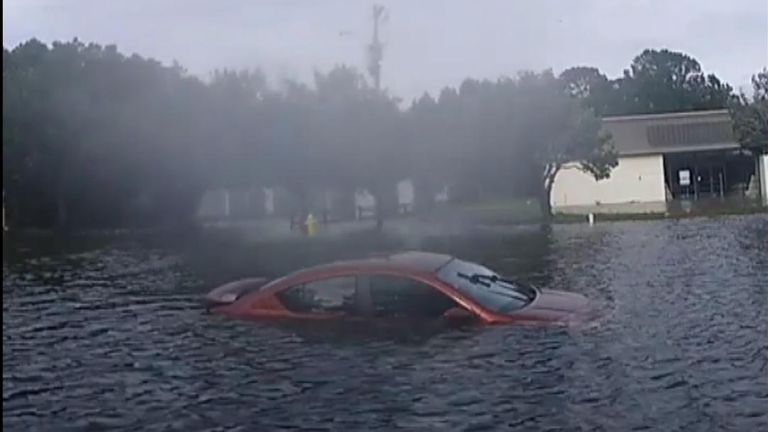 Two cops in Mississippi rescued two women who became stranded in a car surrounded by floodwater from Tropical Depression Ida.