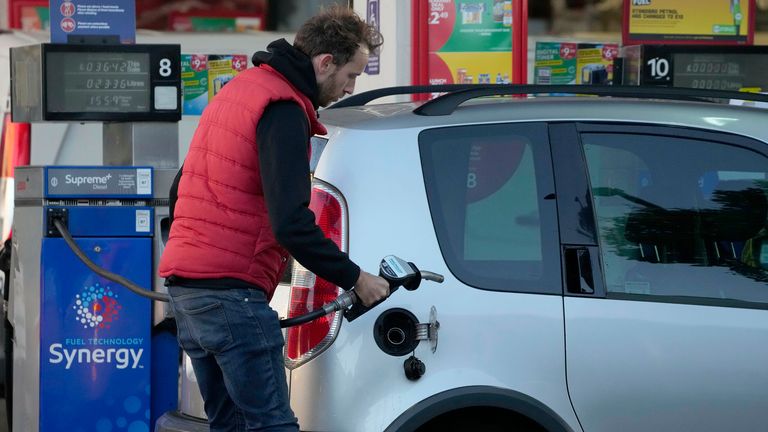 A driver fills his car with fuel at a petrol station in London, Wednesday, Sept. 29, 2021