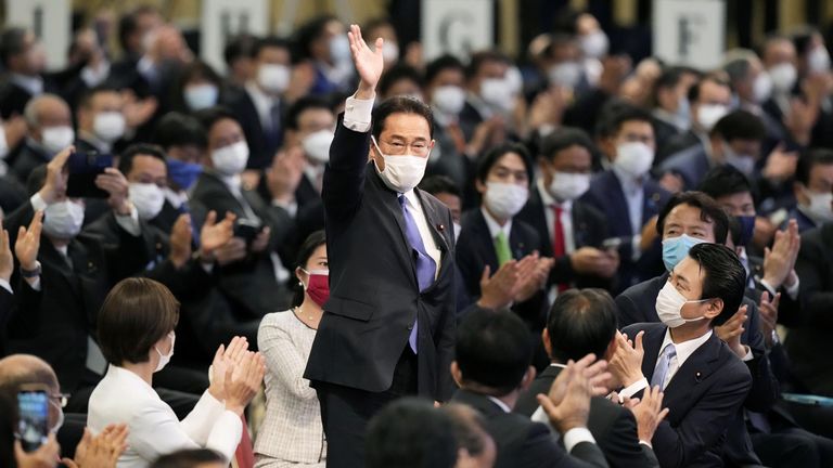Former Japanese Foreign Minister Fumio Kishida waves as he is elected as new head of the ruling party in the Liberal Democratic Party