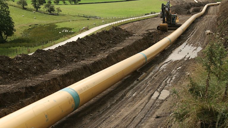 An engineer walks along a stretch of pipeline near Skipton in northern England August 21, 2006. 