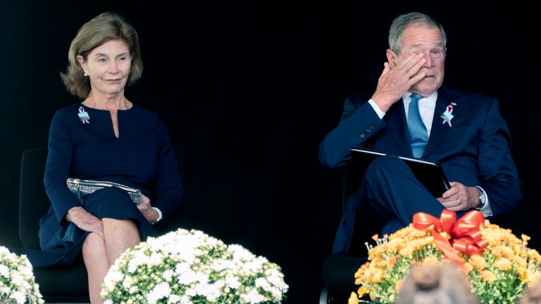 Former President George W. Bush, right, wipes his eyes next to former First Lady Laura Bush after he spoke at a memorial for the passengers and crew of United Flight 93, Saturday, Sept. 11, 2021, in Shanksville, Pa., on the 20th anniversary of the Sept. 11, 2001, attacks. (AP Photo/Jacquelyn Martin)