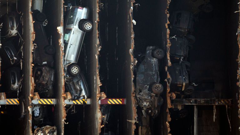 The bow section of the vehicle carrier Golden Ray, with some of the 4,000 vehicles onboard, waits to be towed to a scrap yard, Tuesday, Dec. 1, 2020, in Brunswick, Ga. The salvage operation uses a heavy lift twin gantries with a chain to cut the vessel into seven pieces before they are lifted onto a barge and scrapped. (AP Photo/Stephen B. Morton)


