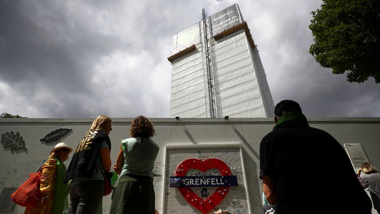 People attend a commemoration to mark the third anniversary of the Grenfell Tower fire in London.
