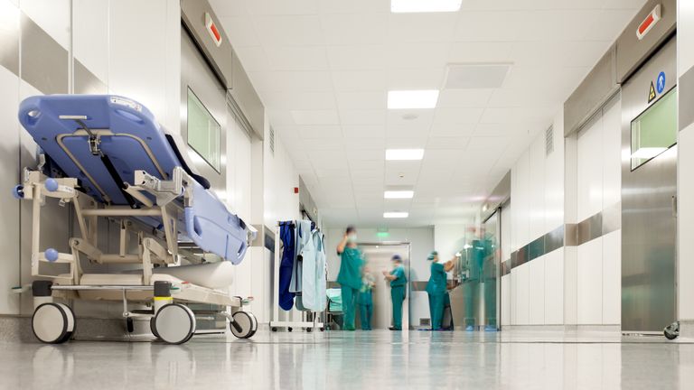 Blurred figures of people with medical uniforms in hospital corridor. Pic: iStock