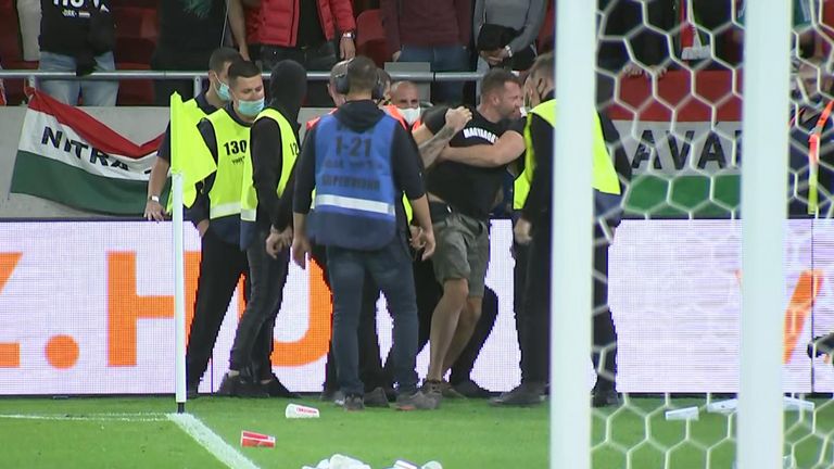 A Hungary fan being led away after the final whistle 