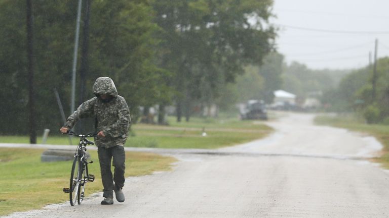 A pedestrian walks his bike in the rain as Tropical Storm Nicholas approaches in Matagorda, Texas on Monday, Sept. 13
pic:AP
