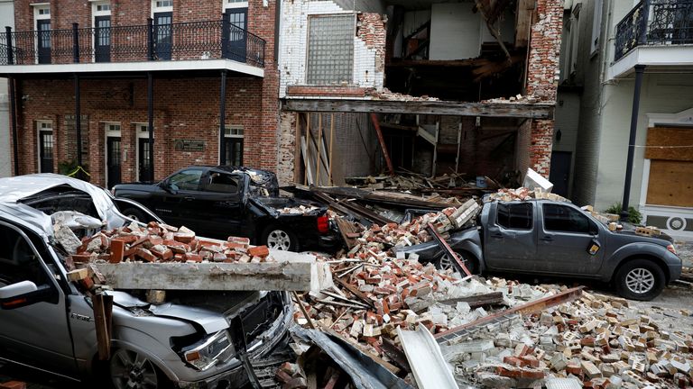 Destroyed cars are seen under debris from a collapsed facade after Hurricane Ida made landfall in Louisiana, 
September 1, 2021