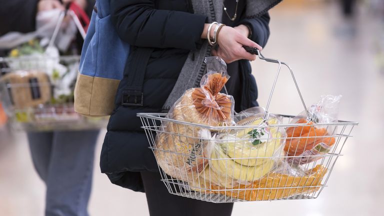 Undated file photo of a woman shopping holding a basket. Issued 1/9/2021