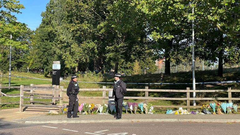 Police beside floral tributes left at Cator Park 