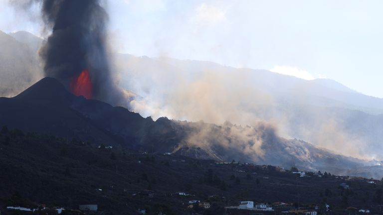 Lava and smoke rise following the eruption of a volcano on the Canary Island of La Palma, in Tajuya, Spain, September 25, 2021. REUTERS/Nacho Doce