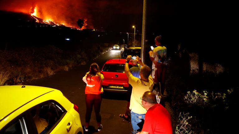 Residents watch lava following the eruption