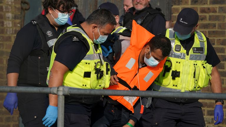 A group of people thought to be migrants are brought in to Dover, Kent, by Border Force officers, following a small boat incident in the Channel. Picture date: Thursday September 16, 2021.