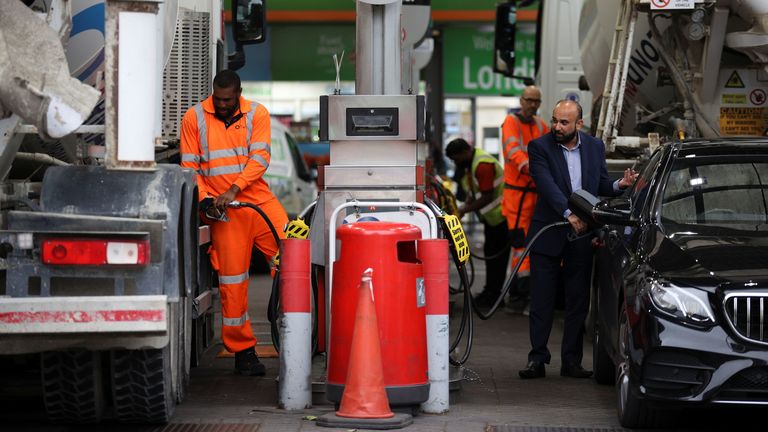 People refuel their vehicles at a fuel station in London, Britain, September 30, 2021. REUTERS/Hannah McKay
