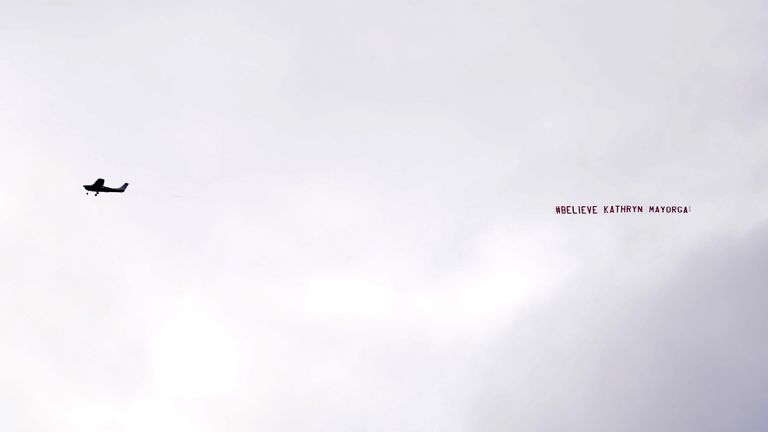 A banner reading "#Belive Kathryn Mayorga&#39; flew over Old Trafford 