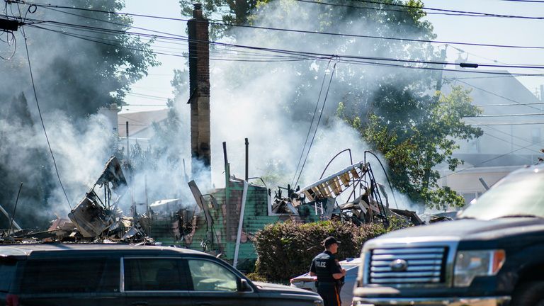 A Manville Police Officer stands guard near the remains of a house that exploded due to severe flooding from Tropical Storm Ida in Manville, NJ., Friday, Sept. 3, 2021. Pic: AP