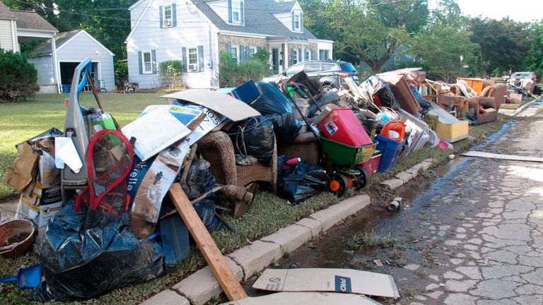 This Sept. 3, 2021 photo shows ruined household possessions at the curb in Manville N.J. two days after the remnants of Tropical Storm Ida caused massive flooding in the New Jersey town near the Raritan River. (AP Photo/Wayne Parry)