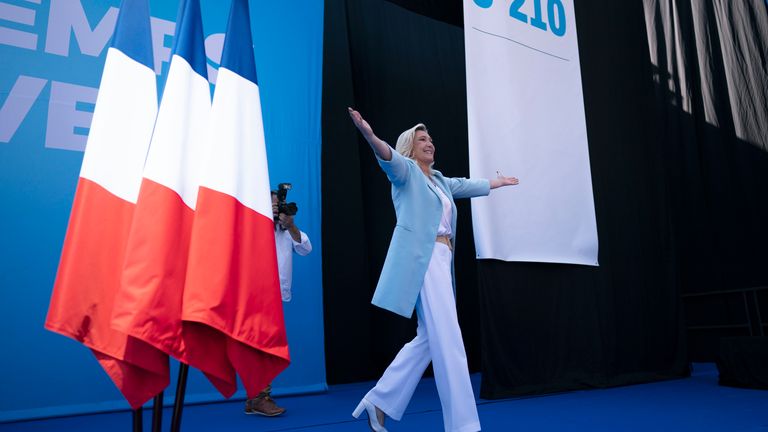 Marine Le Pen arrives at a National Rally event in Frejus, Sunday, Sept. 12, 2021. French far right leader Marine Le Pen hands over the reins of her party to focus on her campaign for the April presidential election, and the Socialist mayor of Paris declares she is joining the 2022 race. (AP Photo/Daniel Cole)