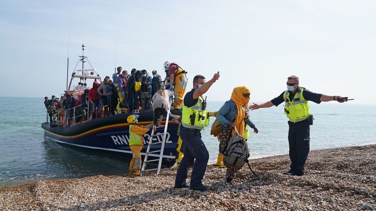 A group of people thought to be migrants are brought ashore from the local lifeboat at Dungeness in Kent, after being picked-up following a small boat incident in the Channel. Picture date: Monday September 6, 2021.