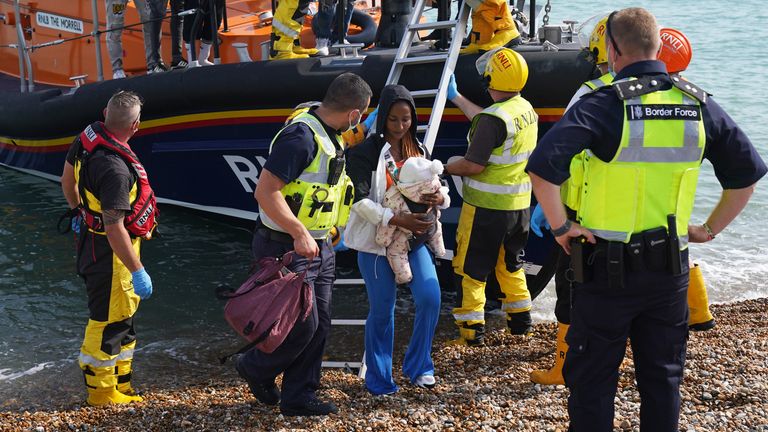 A group of people thought to be migrants are brought ashore from the local lifeboat at Dungeness in Kent, after being picked-up following a small boat incident in the Channel. Picture date: Monday September 6, 2021.