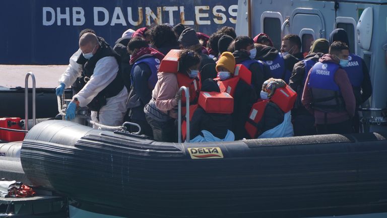 The arrivals, all thought to be migrants, are seen wearing masks and life jackets