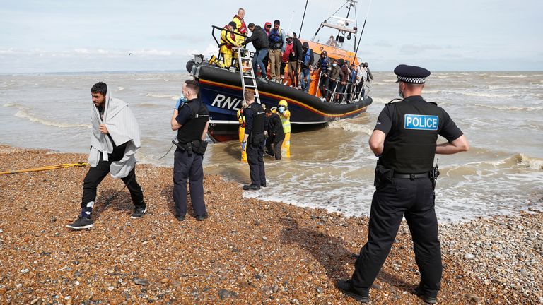 A RNLI boat, with migrants rescued from the English Channel by UK Border Force onboard, is met by Border Force Officers and Police at the harbour in Dungeness, Britain, September 13, 2021. REUTERS/Peter Nicholls