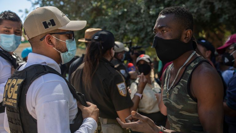 A Haitian migrant pleads with a Mexican police officer blocking access to the Rio Grande river so that immigrants can&#39;t use it to cross the U.S.-Mexico border from Ciudad Acuña, Mexico
PIC:AP
