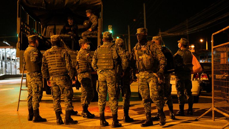 Members of the military gather outside of the Penitenciaria del Litoral