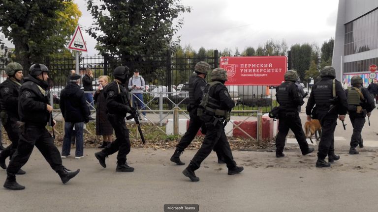 Law enforcement officers work near the scene after a gunman opened fire at the Perm State University in Perm, Russia September 20, 2021, in this still image taken from video. REUTERS/Anna Vikhareva NO RESALES. NO ARCHIVES