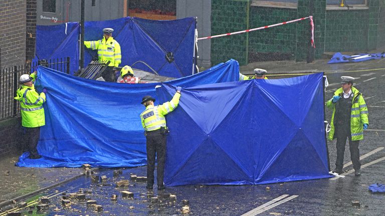 Emergency services at the scene on the Great Western Road, Notting Hill, west London, where three people have died after a vehicle collided with a residential block