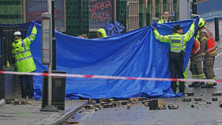 Emergency services at the scene on the Great Western Road, Notting Hill, west London, where three people have died after a vehicle collided with a residential block