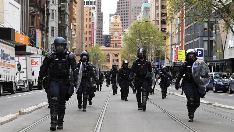 riot police respond to protesters rallying against construction industry COVID-19 mandates in Melbourne