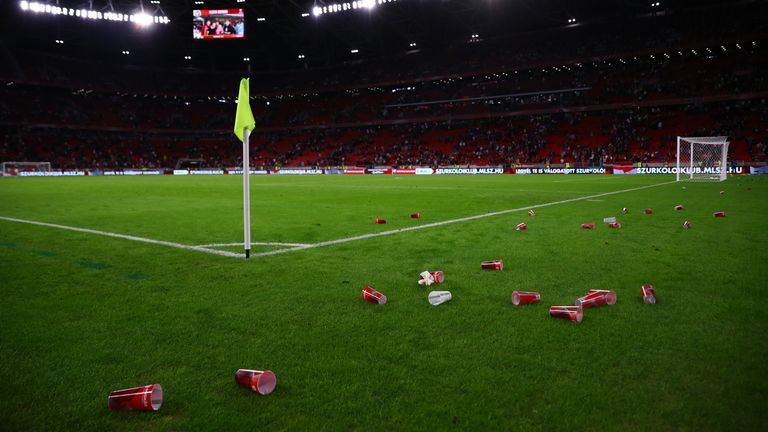 Plastic cups litter the pitch after the final whistle