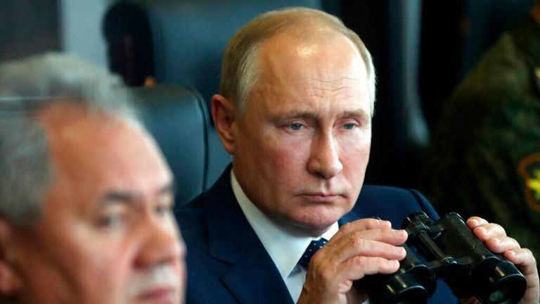 Russian President Vladimir Putin, right, holds a binoculars as Russian Defense Minister Sergei Shoigu sits near watching the joint strategic exercise of the armed forces of the Russian Federation and the Republic of Belarus Zapad-2021 at the Mulino training ground in the Nizhny Novgorod region, Russia, Monday, Sept. 13, 2021. 