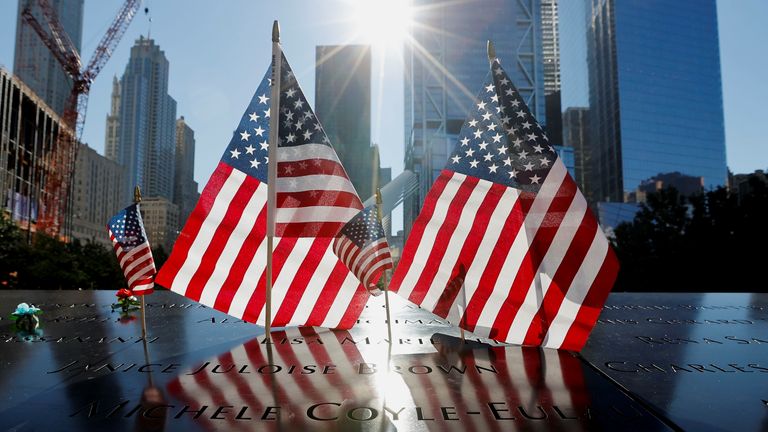 Flags were placed alongside flowers in the memorial for 9/11 victims in New York. Pic: Reuters