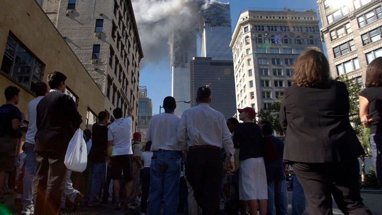 People watch smoke billow from the Twin Towers. Pic: AP