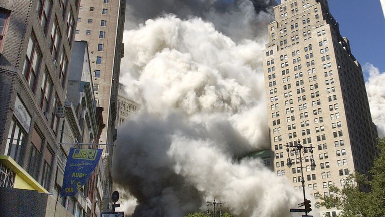 People flee the falling South Tower of the World Trade Center on Tuesday, September 11, 2001.  (AP Photo/Amy Sancetta)