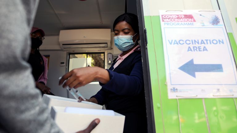 A healthcare worker picked up syringes containing COVID-19 vaccine in Johannesburg, South Africa