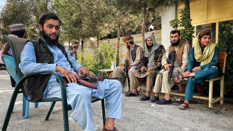 Taliban fighters outside their house