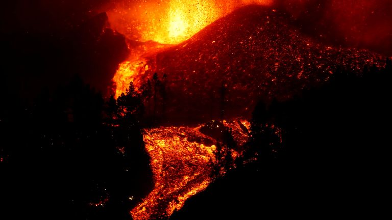 Lava flows downhill following the eruption of a volcano in Spain
